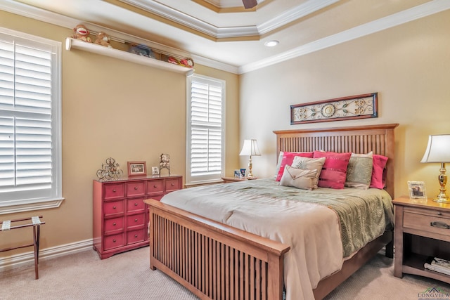 bedroom featuring ceiling fan, light colored carpet, a raised ceiling, and ornamental molding