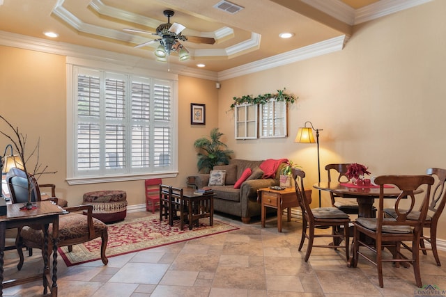 sitting room with ceiling fan, crown molding, and a tray ceiling