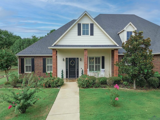 view of front of home featuring a porch and a front lawn