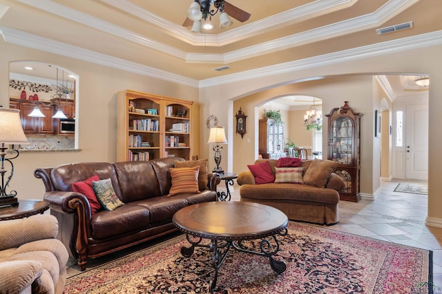 living room featuring crown molding and a healthy amount of sunlight