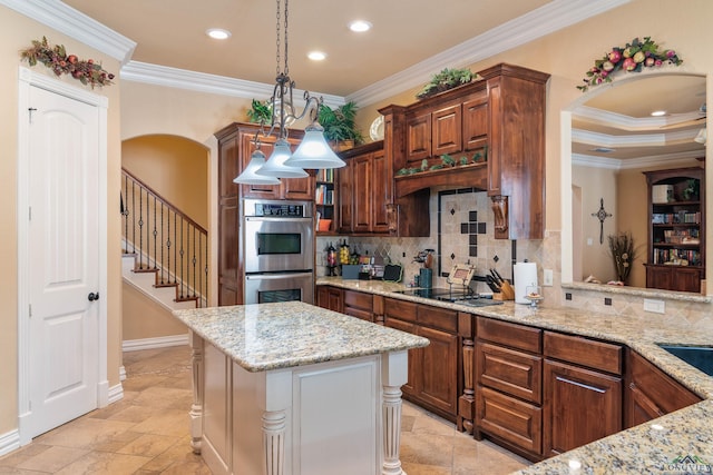 kitchen featuring ornamental molding, a center island, stainless steel double oven, and light stone countertops