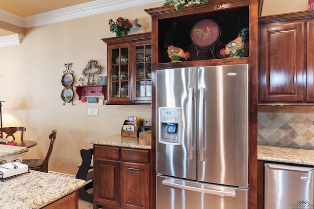 kitchen featuring ornamental molding, stainless steel fridge, backsplash, and light stone countertops