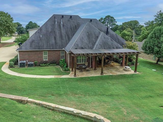 back of property with a patio, a yard, and central AC unit