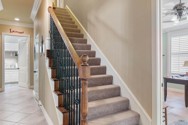 stairs with ceiling fan, crown molding, and tile patterned floors