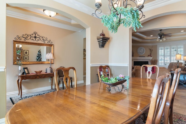 dining area with ceiling fan, crown molding, and a tray ceiling