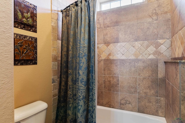 bathroom featuring toilet and shower / bathtub combination with curtain