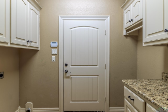 washroom with cabinets and hookup for an electric dryer