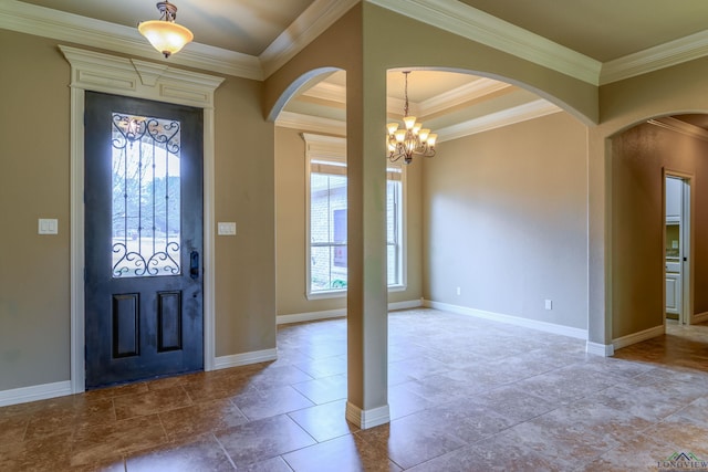 foyer entrance with a notable chandelier and ornamental molding