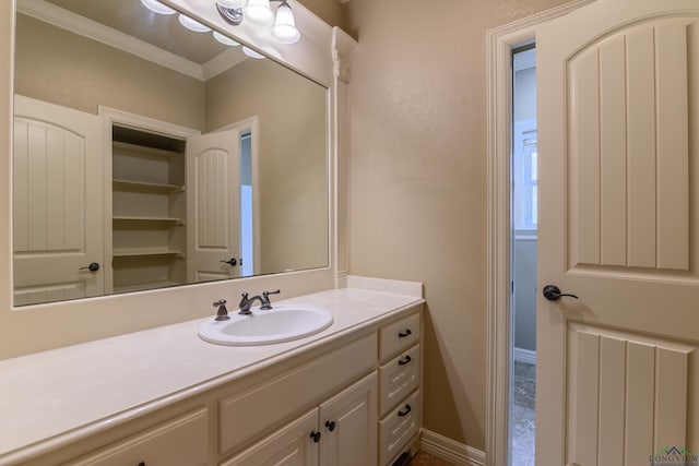 bathroom with vanity and crown molding