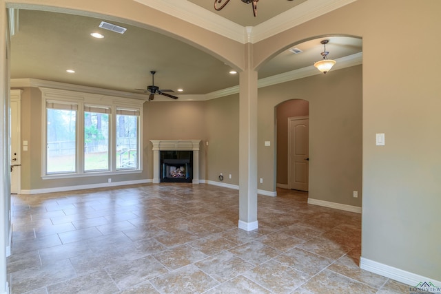 unfurnished living room featuring crown molding, ceiling fan, and a premium fireplace