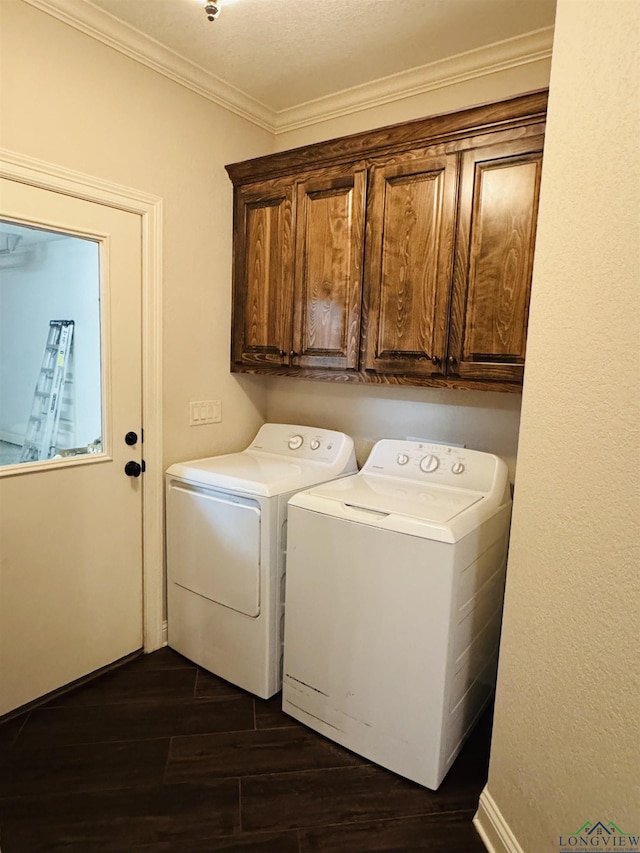 washroom with washing machine and dryer, dark hardwood / wood-style flooring, crown molding, and cabinets