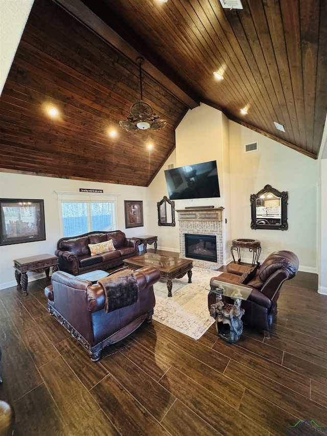 living room with ceiling fan, vaulted ceiling with beams, a fireplace, and wooden ceiling