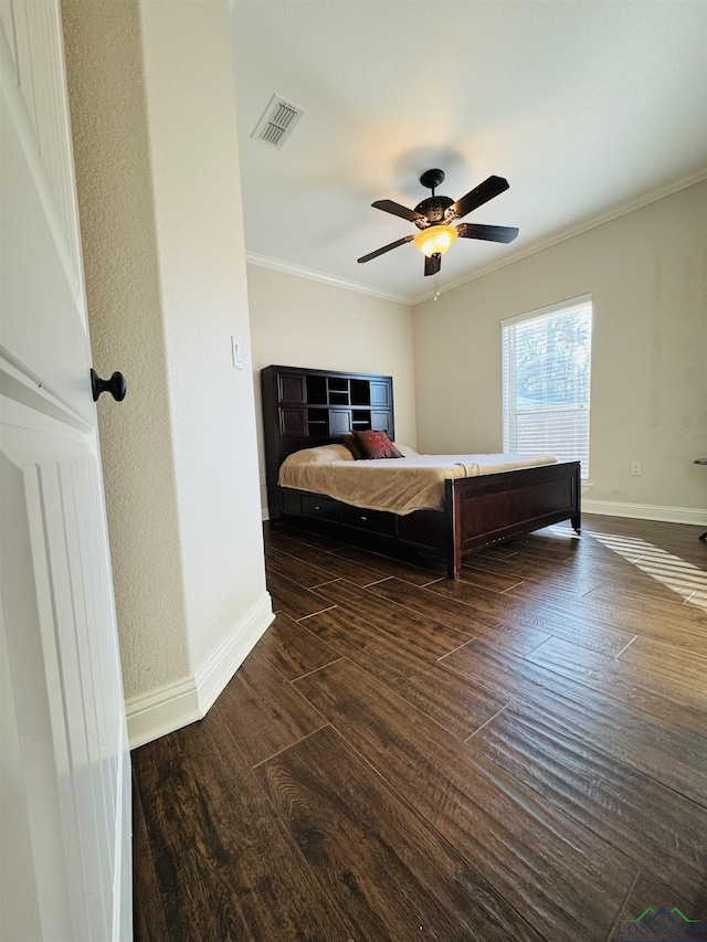 bedroom featuring ceiling fan, dark hardwood / wood-style flooring, and crown molding