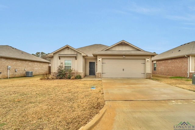 ranch-style house with a garage, central AC unit, and a front lawn