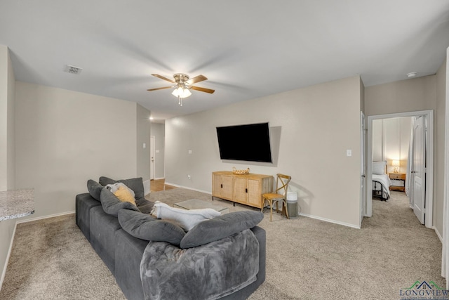 carpeted living room with ceiling fan