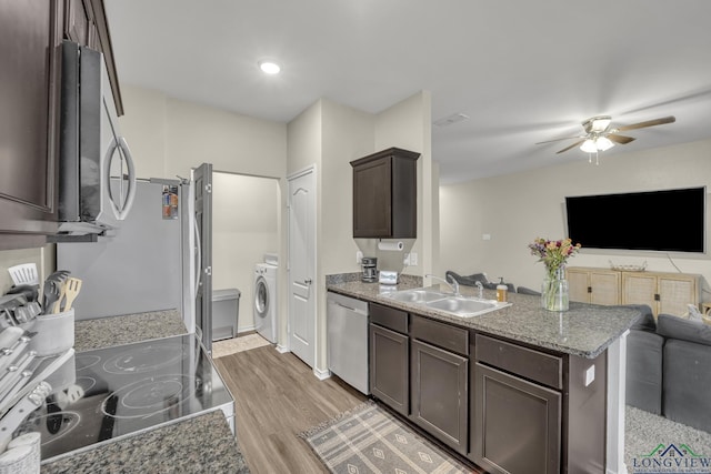 kitchen featuring sink, ceiling fan, appliances with stainless steel finishes, dark brown cabinetry, and washer / dryer