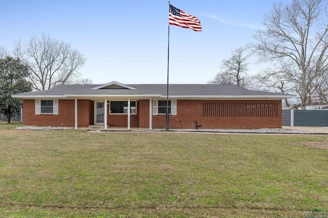 ranch-style home with a front yard, fence, and brick siding