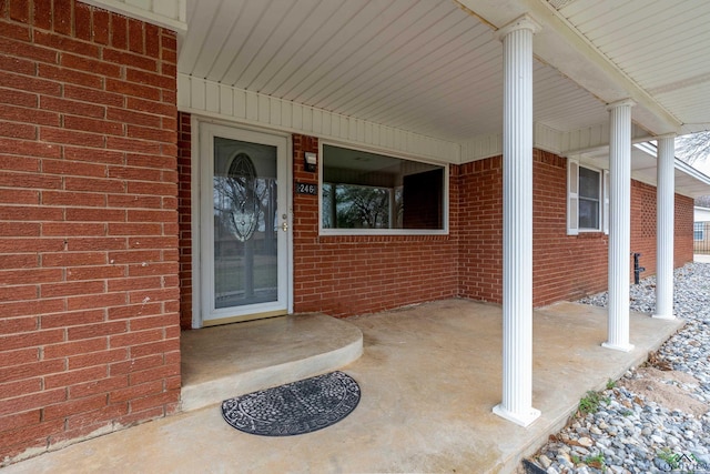 view of exterior entry featuring brick siding