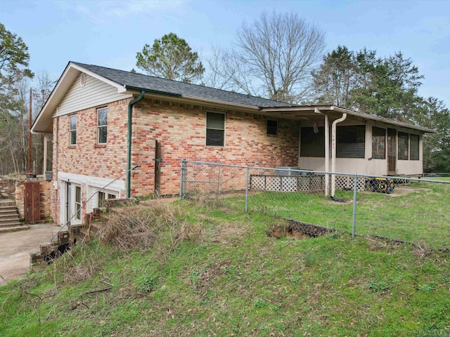 view of front of property with a front yard and a sunroom