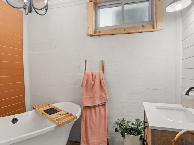 bathroom with a tub to relax in and vanity