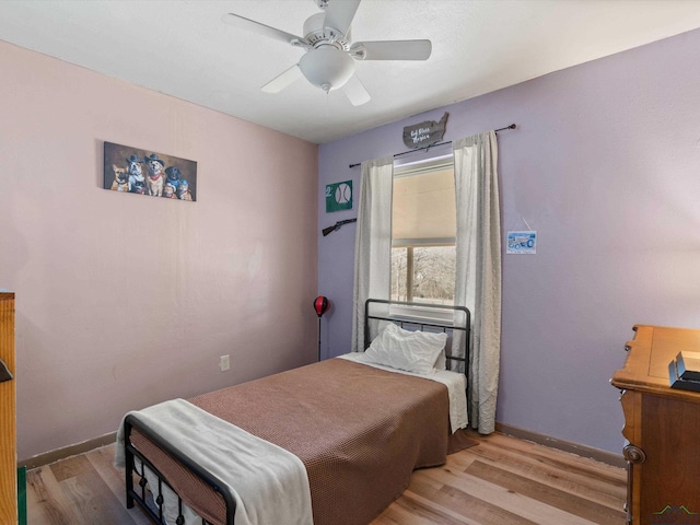 bedroom featuring ceiling fan and light hardwood / wood-style flooring