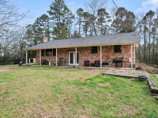 view of front of home featuring a front lawn and a patio