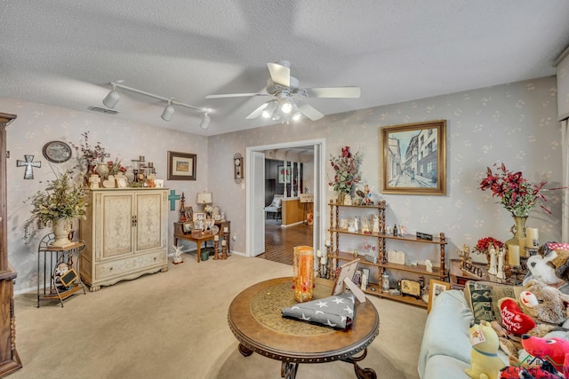 interior space featuring carpet, ceiling fan, a textured ceiling, and track lighting