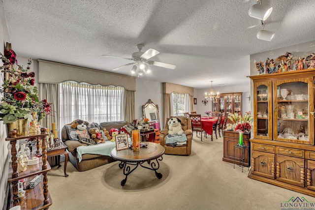 carpeted living room with ceiling fan with notable chandelier and a textured ceiling