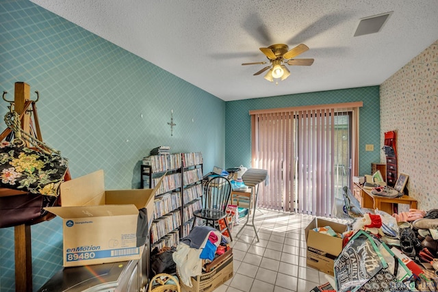 miscellaneous room with light tile patterned floors, a textured ceiling, and ceiling fan