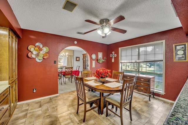 dining room featuring ceiling fan with notable chandelier