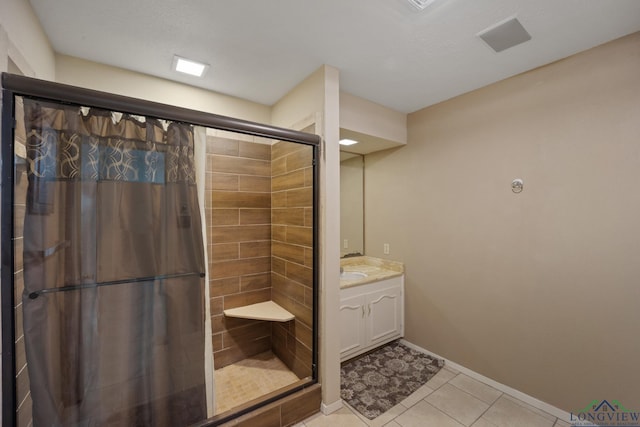 bathroom featuring tile patterned floors, vanity, walk in shower, and a textured ceiling