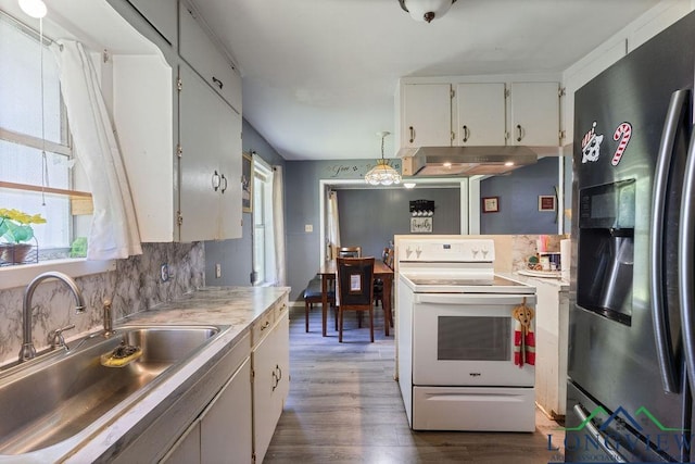 9819 US Highway 84e, Joaquin, TX 75954 - kitchen featuring stainless steel fridge, white range with electric stovetop, a sink, under cabinet range hood, and light countertops