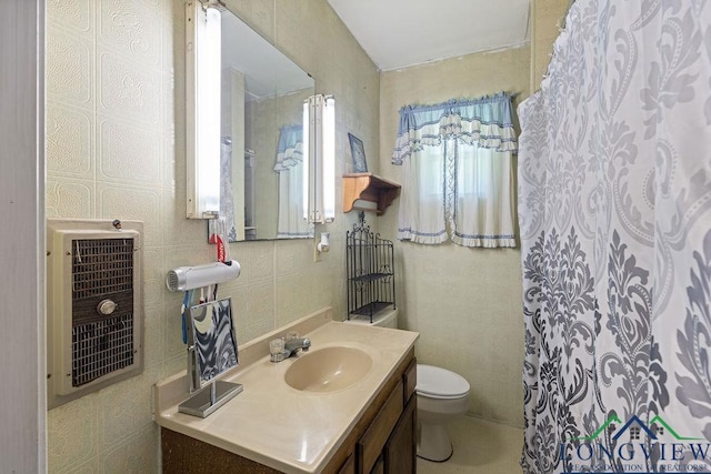 9819 US Highway 84e, Joaquin, TX 75954 - bathroom with vanity, toilet, a shower with curtain, heating unit, and tile walls