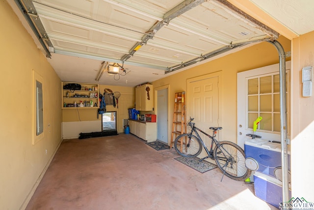 garage featuring electric panel and a garage door opener