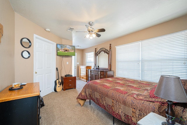 bedroom featuring ceiling fan, visible vents, and light colored carpet