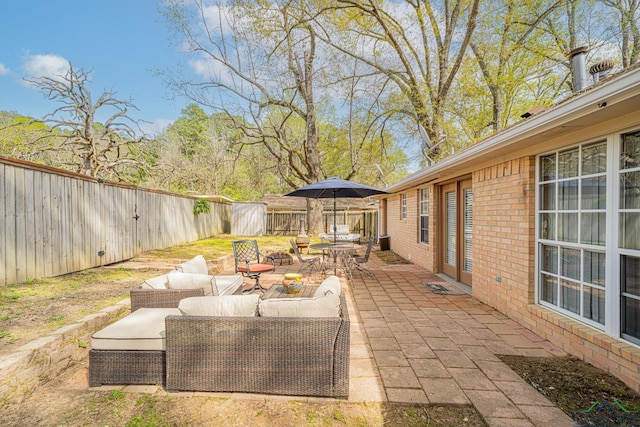 view of patio / terrace featuring outdoor lounge area, outdoor dining area, and a fenced backyard