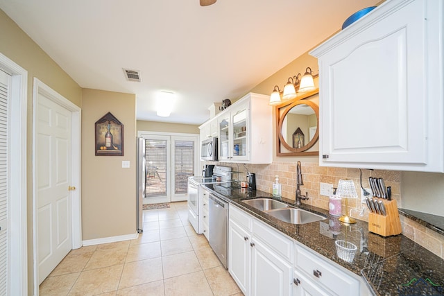 kitchen with white cabinets, a sink, visible vents, backsplash, and appliances with stainless steel finishes