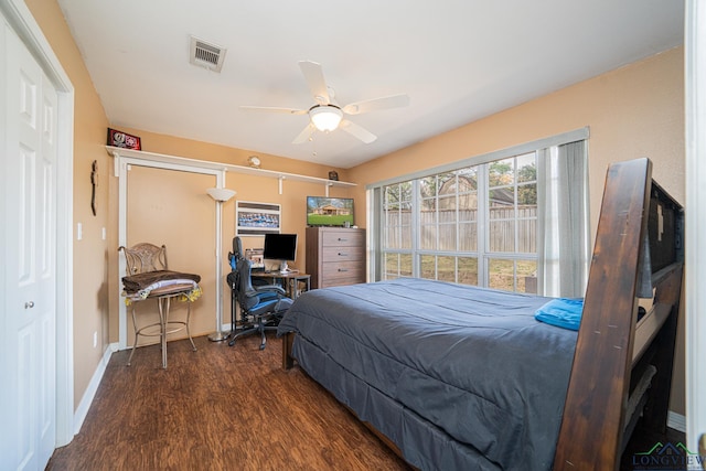 bedroom featuring baseboards, a ceiling fan, wood finished floors, and visible vents