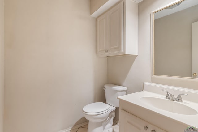 bathroom with tile patterned floors, vanity, and toilet