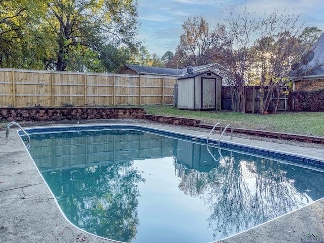 view of swimming pool with a storage shed