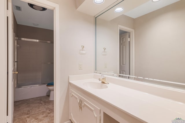 full bathroom featuring vanity, toilet, and enclosed tub / shower combo