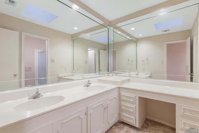 bathroom with a skylight and vanity