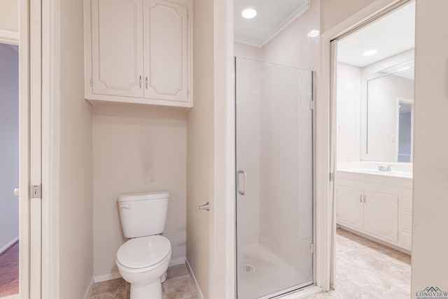 bathroom with crown molding, toilet, walk in shower, and vanity