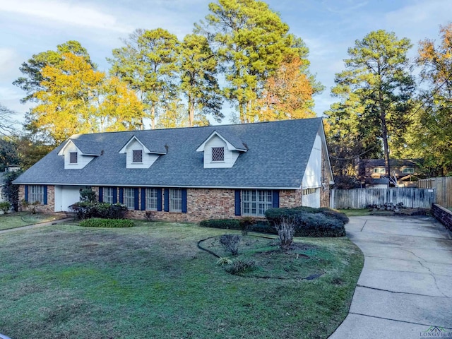 cape cod house featuring a front lawn