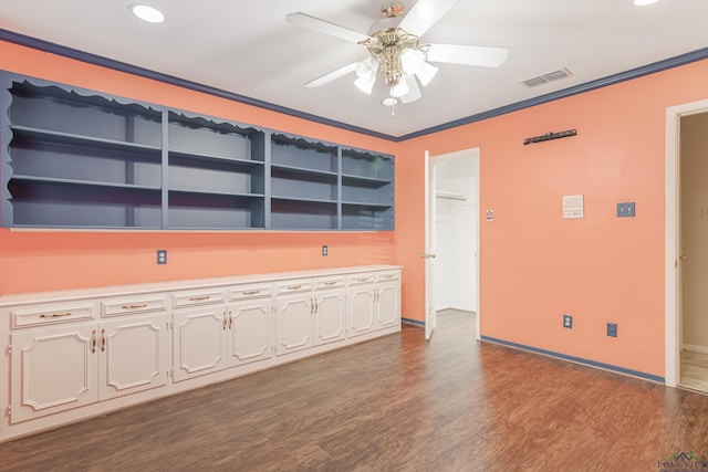 empty room featuring crown molding, ceiling fan, and wood-type flooring