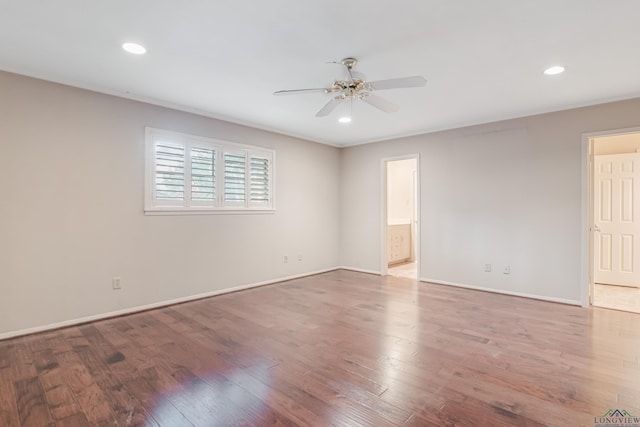 empty room with ceiling fan and wood-type flooring