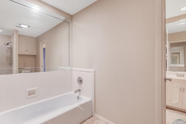 bathroom with vanity and a tub