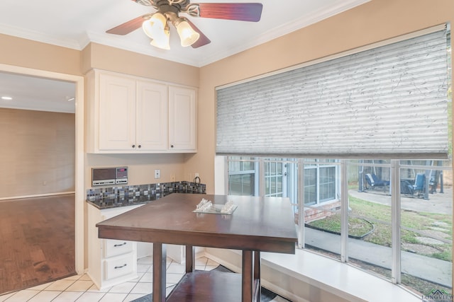 interior space featuring ceiling fan and ornamental molding