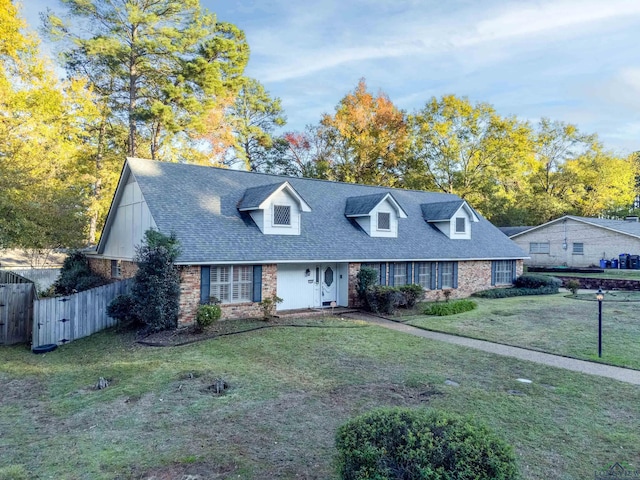 cape cod house with a front lawn