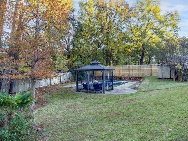 view of yard with a gazebo and a storage shed